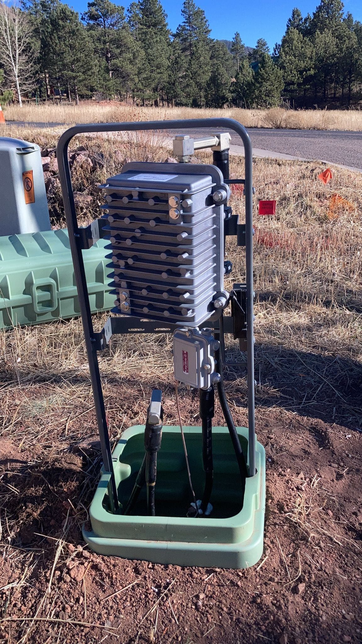 Pedestal frame with a tap block installed over an open ground box
